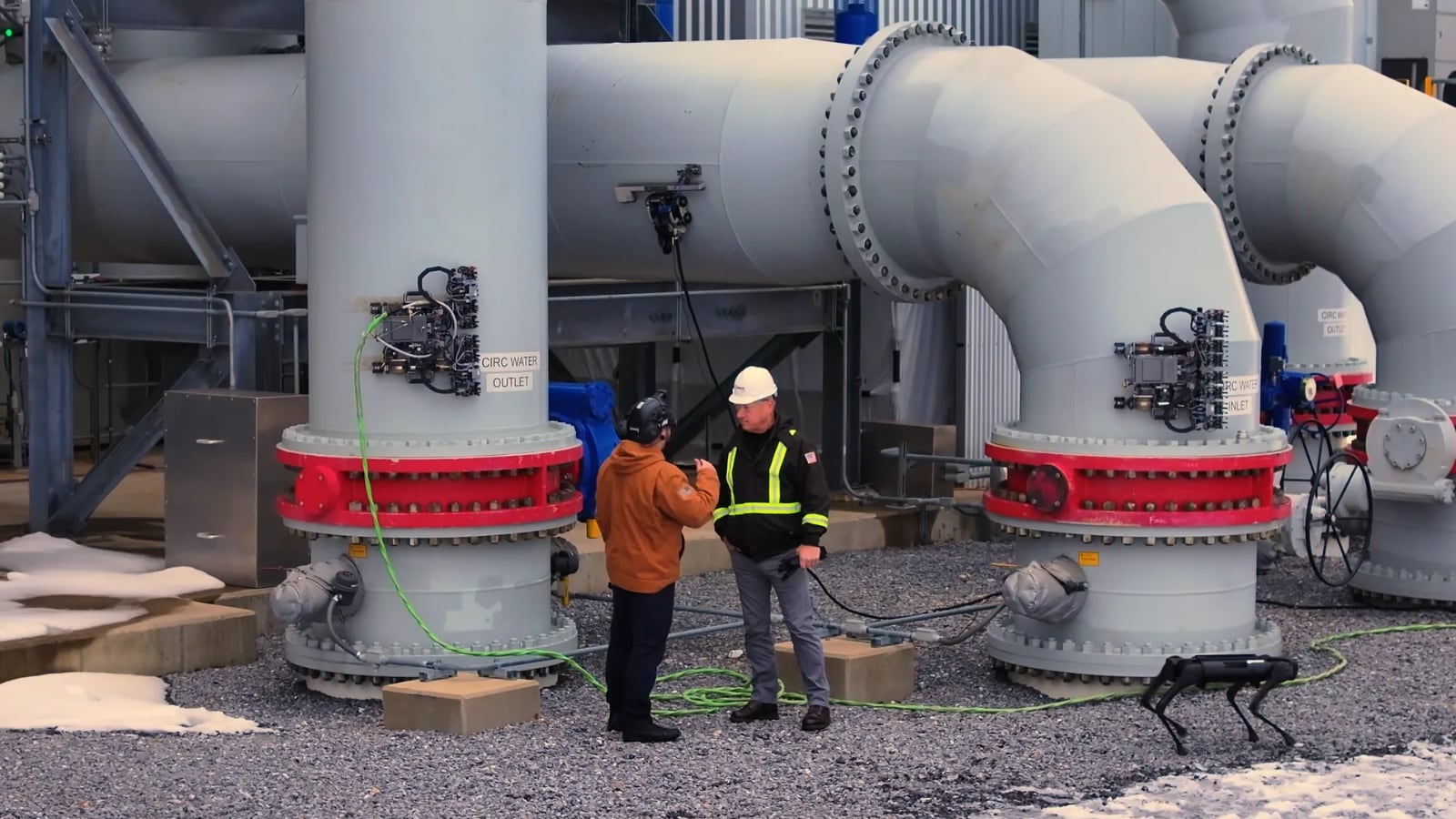 Gecko Robotics: a technician working alongside a robotic inspection unit