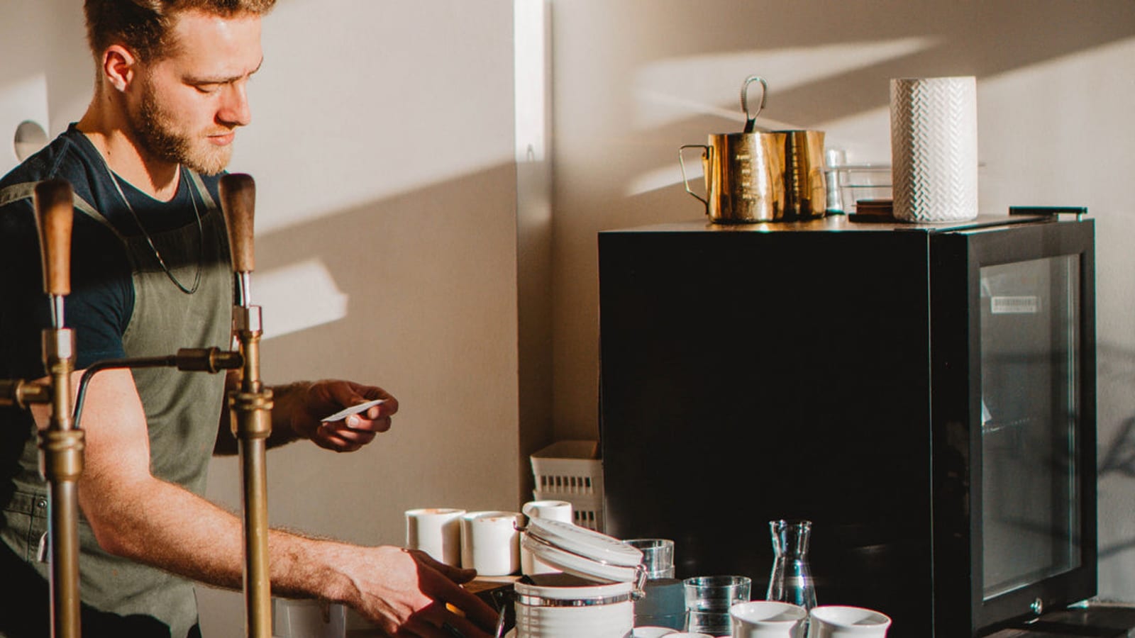 A barista at work behind a cafe counter